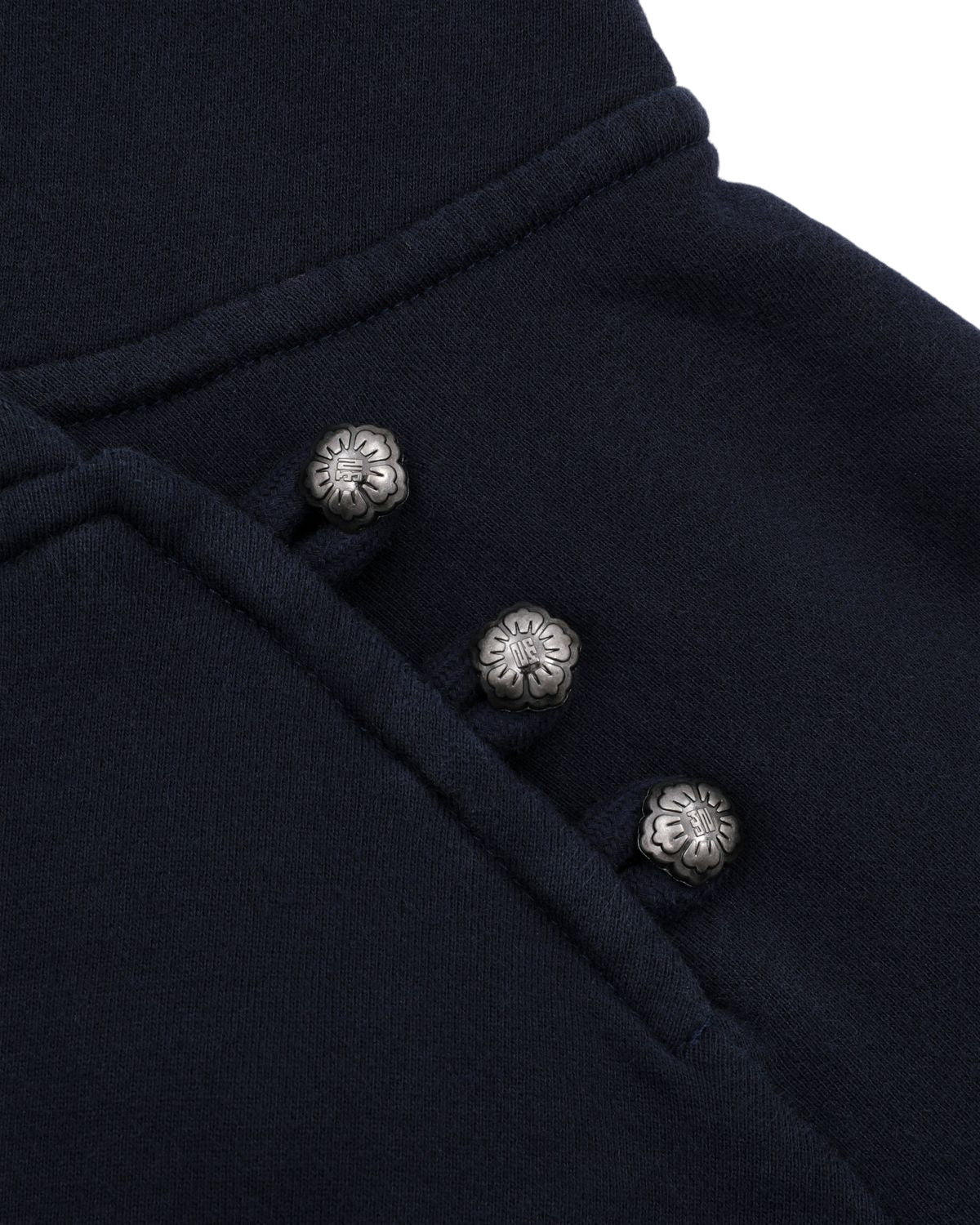 Close-up of the Sundae School NAVY WASH HANBOK HOODIE, featuring dark navy custom cotton fabric with three metallic flower-shaped buttons arranged diagonally.