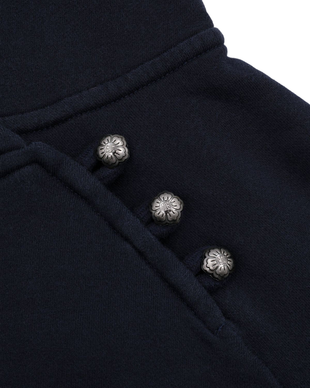 Close-up of the Sundae School NAVY WASH HANBOK HOODIE, featuring dark navy custom cotton fabric with three metallic flower-shaped buttons arranged diagonally.