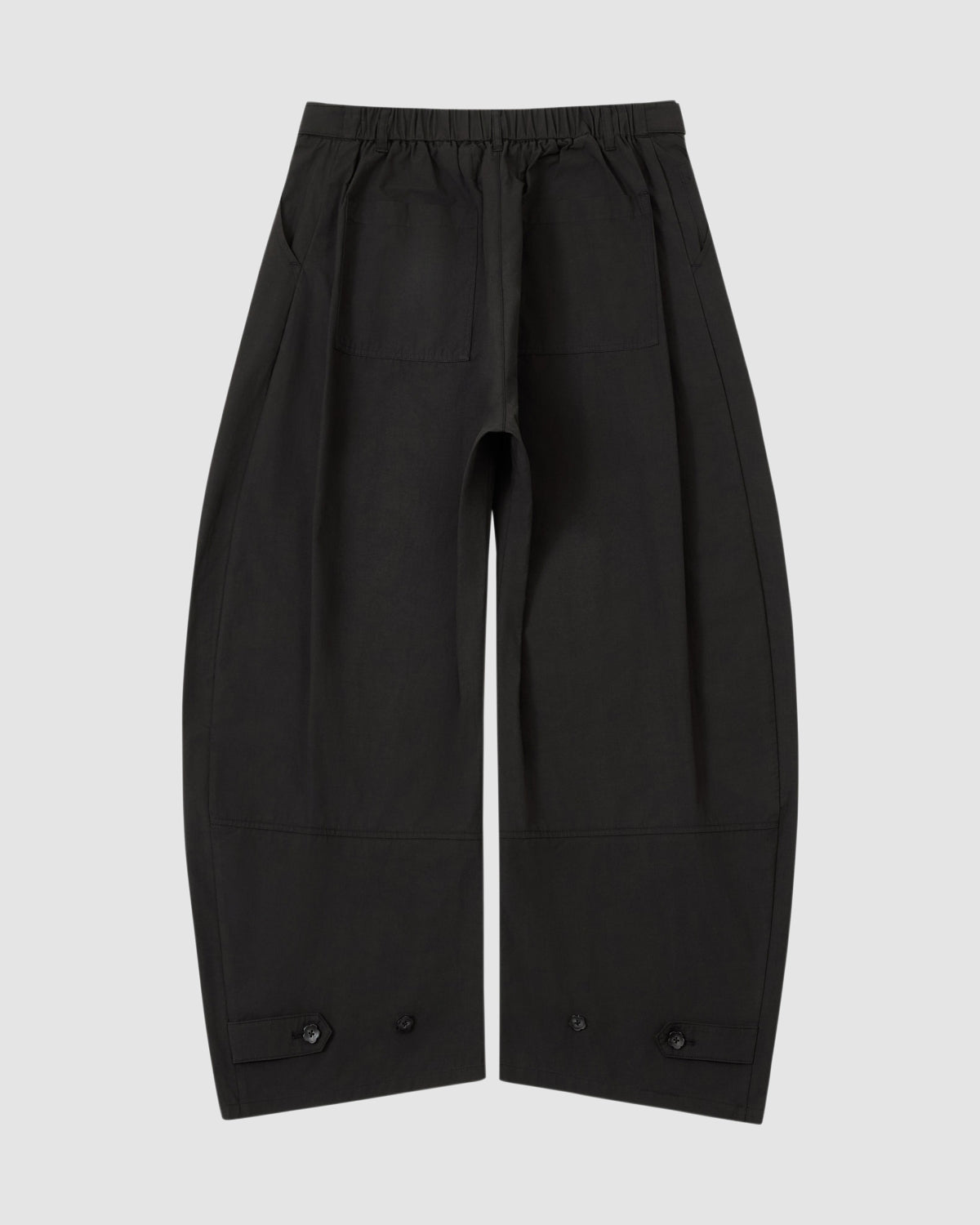 The BLACK HANBOK LINEN PANTS by Sundae School feature a wide barrel leg, elastic adjustable waist, large front patch pockets, and hem buttons, shown flat on a plain light gray background.
