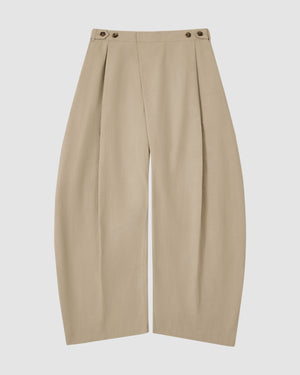 The Sundae School WHEAT HANBOK LINEN PANTS feature a beige cotton-linen blend, high waist, front pleats, wide barrel leg, and adjustable buttoned waistband, shown flat on a white background.