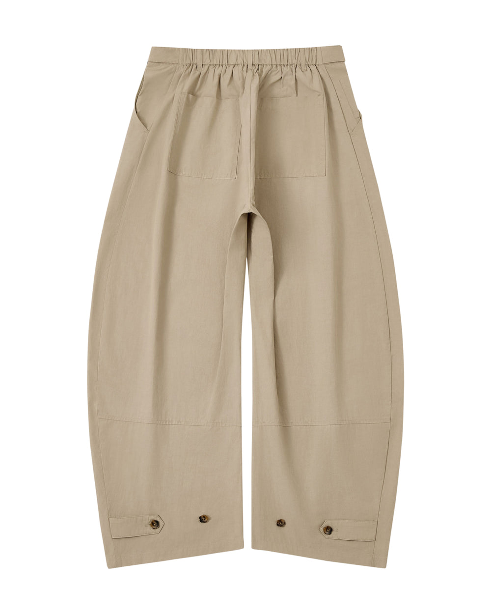 The WHEAT HANBOK LINEN PANTS by Sundae School are beige cotton-linen balloon pants with a wide barrel leg silhouette, an elastic waistband for adjustable fit, two front patch pockets, and button details near the hem, shown laid flat on a white background.