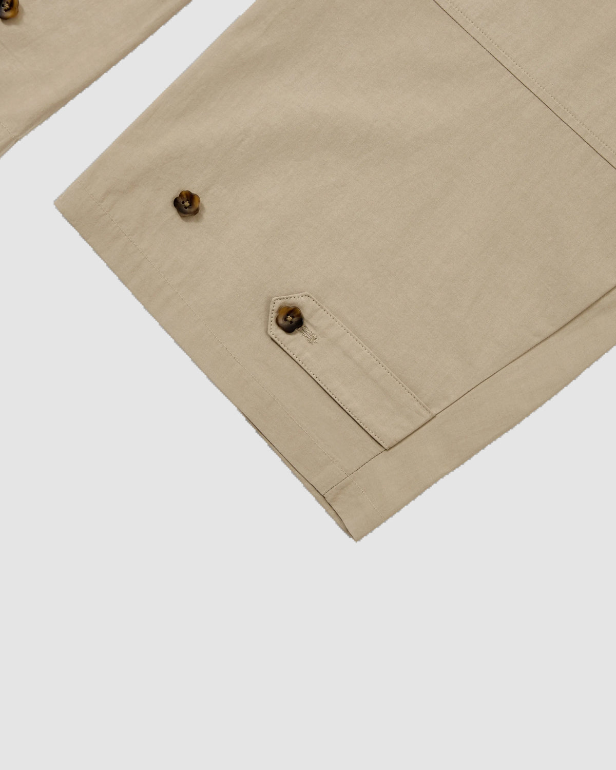 Close-up of a beige sleeve with brown buttons and a cuff flap, styled with Sundae School's WHEAT HANBOK LINEN PANTS for a relaxed, effortless look.