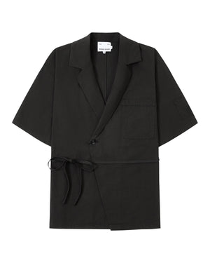 The BLACK HANBOK LINEN SHIRT by Sundae School is a black, short-sleeve blazer-style jacket inspired by the cotton linen hanbok, featuring a chest pocket, side tie closure, single button, and notched lapels, laid flat on a white background.