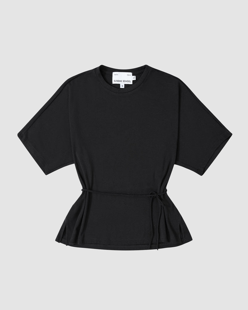 The BLACK BAERAE T-SHIRT by Sundae School is a black short-sleeve Hanbok-inspired tee with a round neckline and waist tie, shown laid flat on a light grey background.