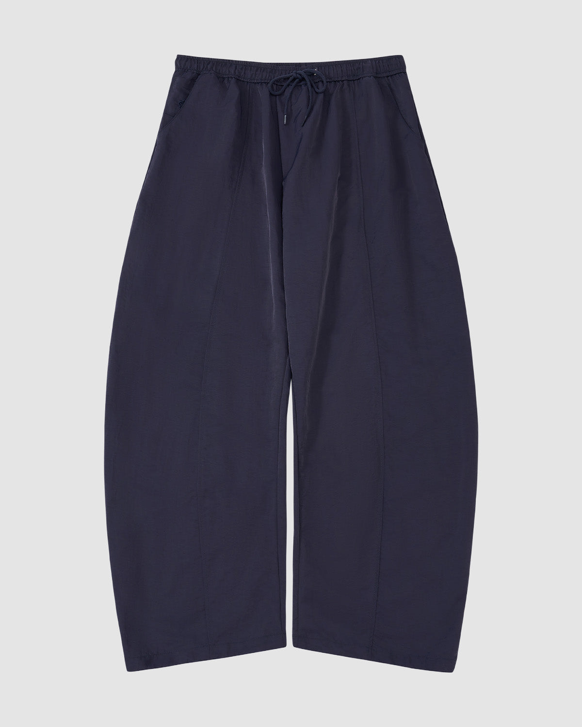 The Sundae School NAVY HANBOK BALLOON TRACK PANTS are loose-fitting, wide-leg navy nylon track pants with an elastic waistband, drawstring, and adjustable hems, shown against a plain light background.