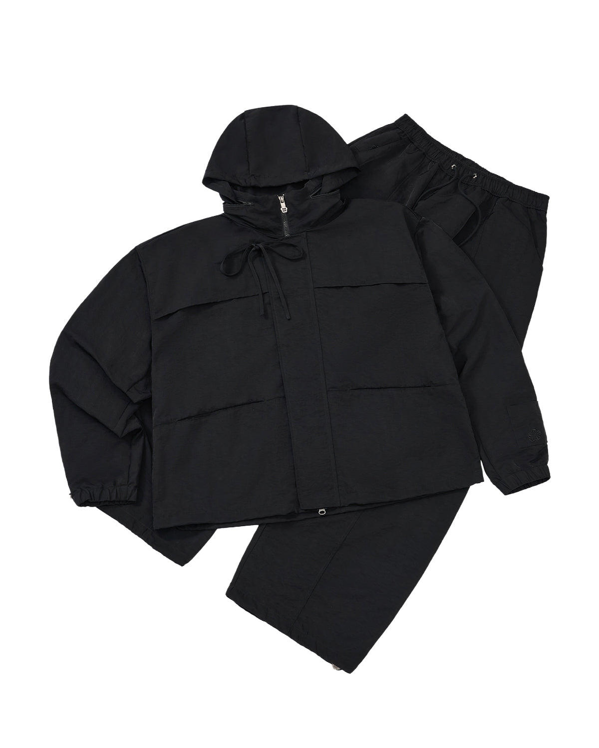 black raincoat and pants set on a light gray background