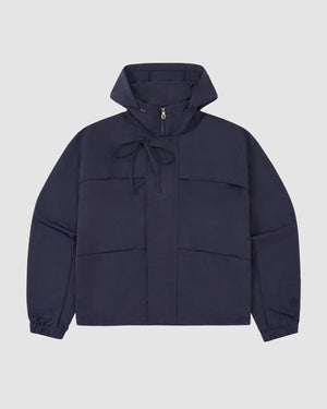The NAVY HANBOK TRACK JACKET by Sundae School is made from lightweight nylon with a custom 떨 zipper pull, drawstring neck, elastic cuffs, and relaxed fit, shown against a plain light gray background.