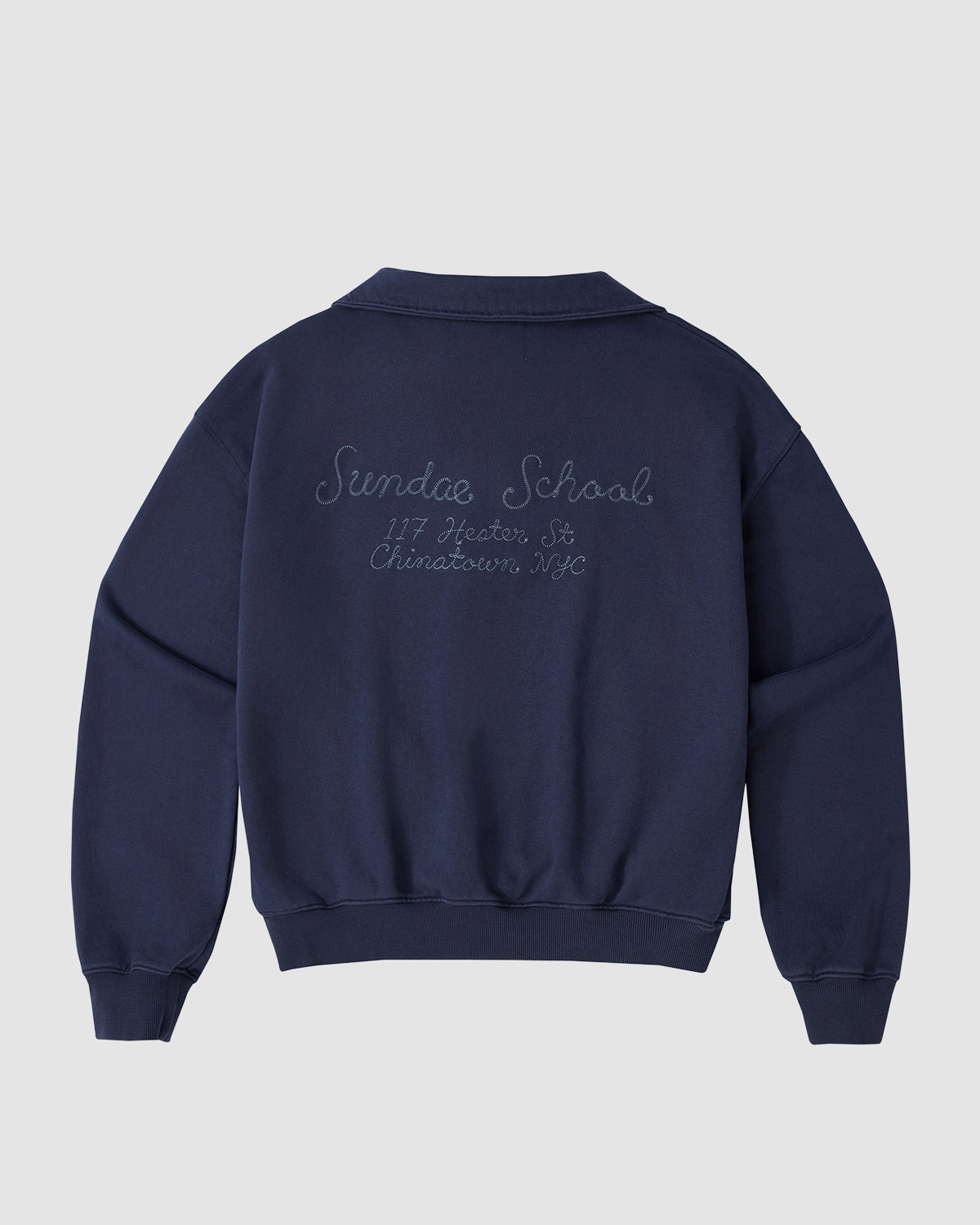 The NAVY HESTER QUARTER ZIP by Sundae School is a vintage cotton pullover with a collar, embroidered Sundae School, 117 Jester St, Chinatown NYC on the back, long sleeves, ribbed cuffs and hem, and a hidden stash pocket for essentials.