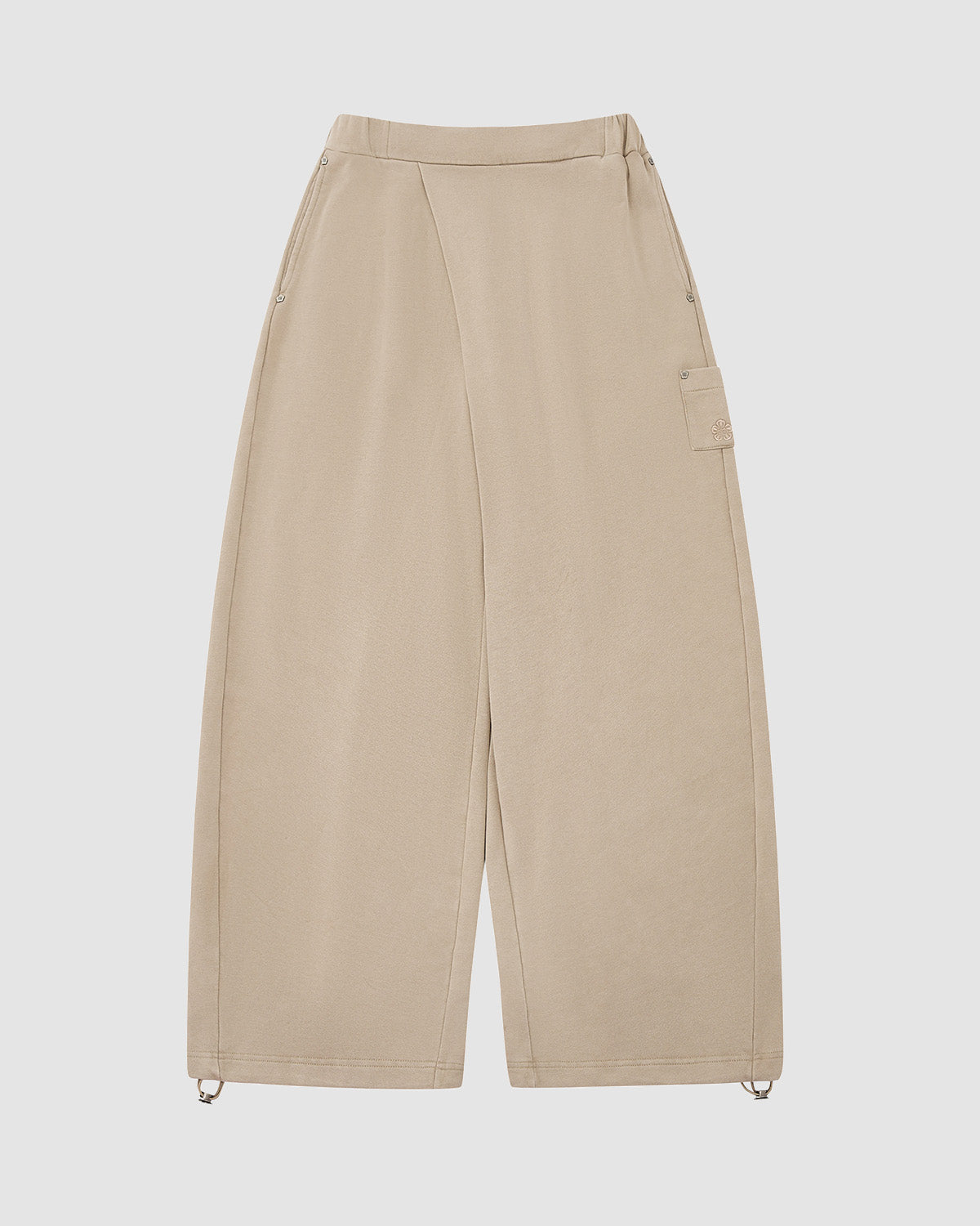 The TAUPE WRAP SWEATBAJI by Sundae School features a high waist, wide legs, side seams, one flap pocket, and ankle drawstrings. Hanbok-inspired and crafted from 100% cotton, these pants are shown laid flat on a white background.