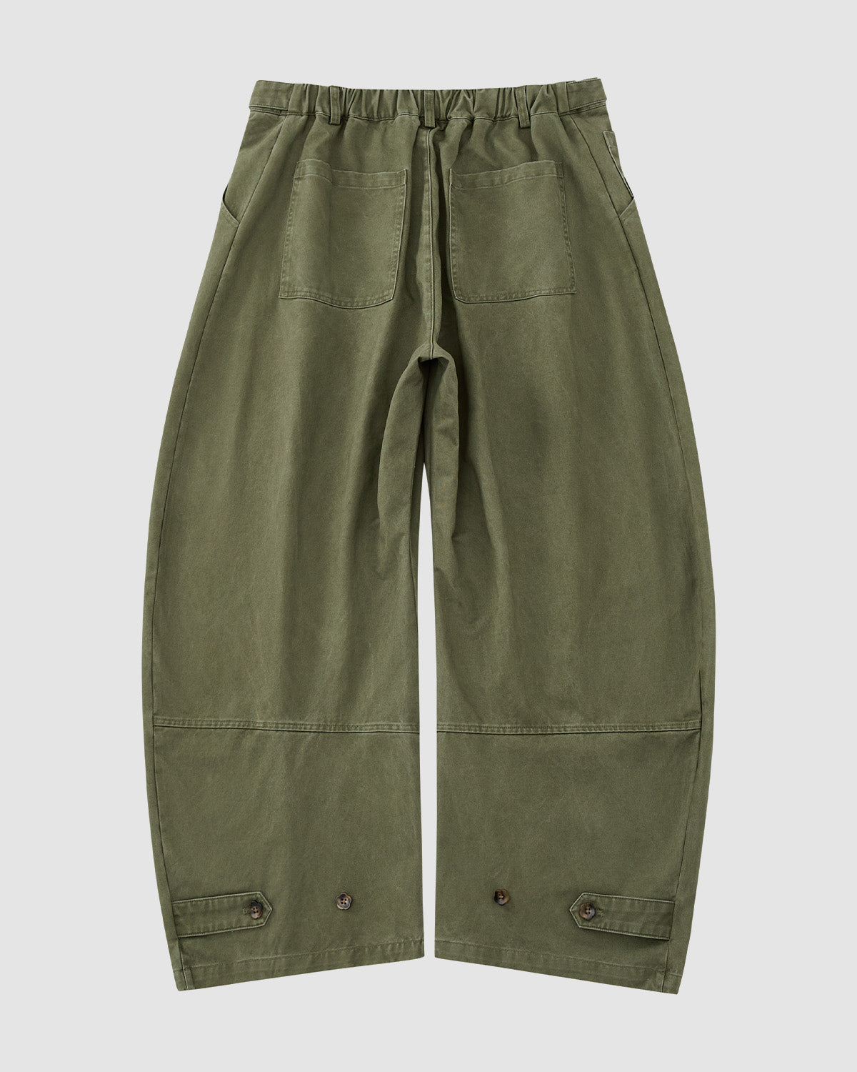The OLIVE HANBOK CHINO PANTS by Sundae School feature a hanbok-inspired silhouette, elastic waistband, large back pockets, and adjustable buttoned cuffs. Displayed on a plain light gray background.