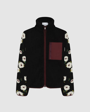 Sundae School Mugunghwa Fleece featuring black sherpa fleece body with white hibiscus flower pattern sleeves, burgundy contrast chest pocket with zipper, full-zip front closure, flat shot on light gray background.