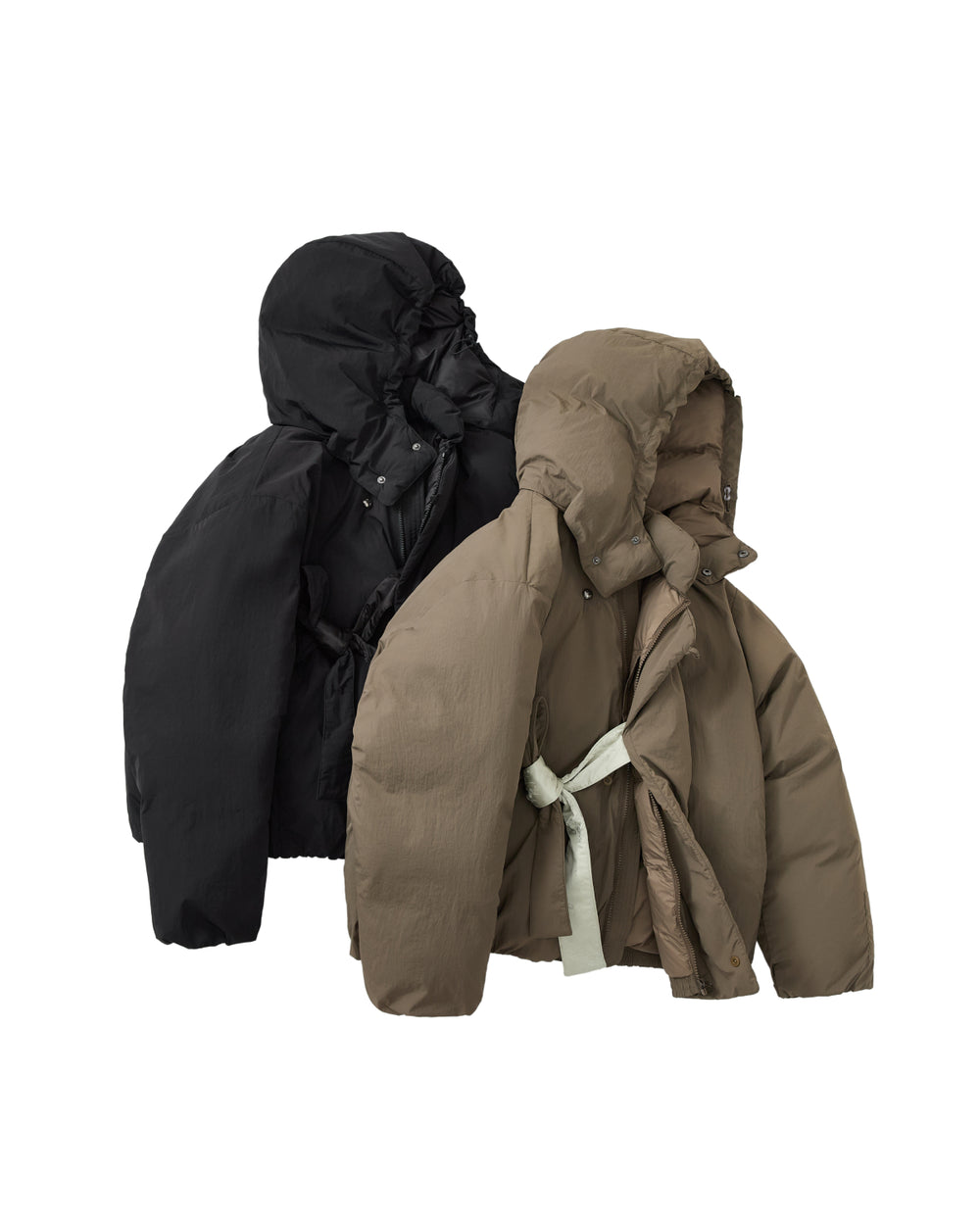 Two puffer jackets from Sundae School are displayed against a white background: one in classic black and the other, the DEEP BROWN IBUL DOWN PUFFER, in rich brown. Both feature cocoon silhouettes and hoods, while the DEEP BROWN IBUL DOWN PUFFER stands out with a light-colored belted waist and a detachable hood for enhanced versatility.