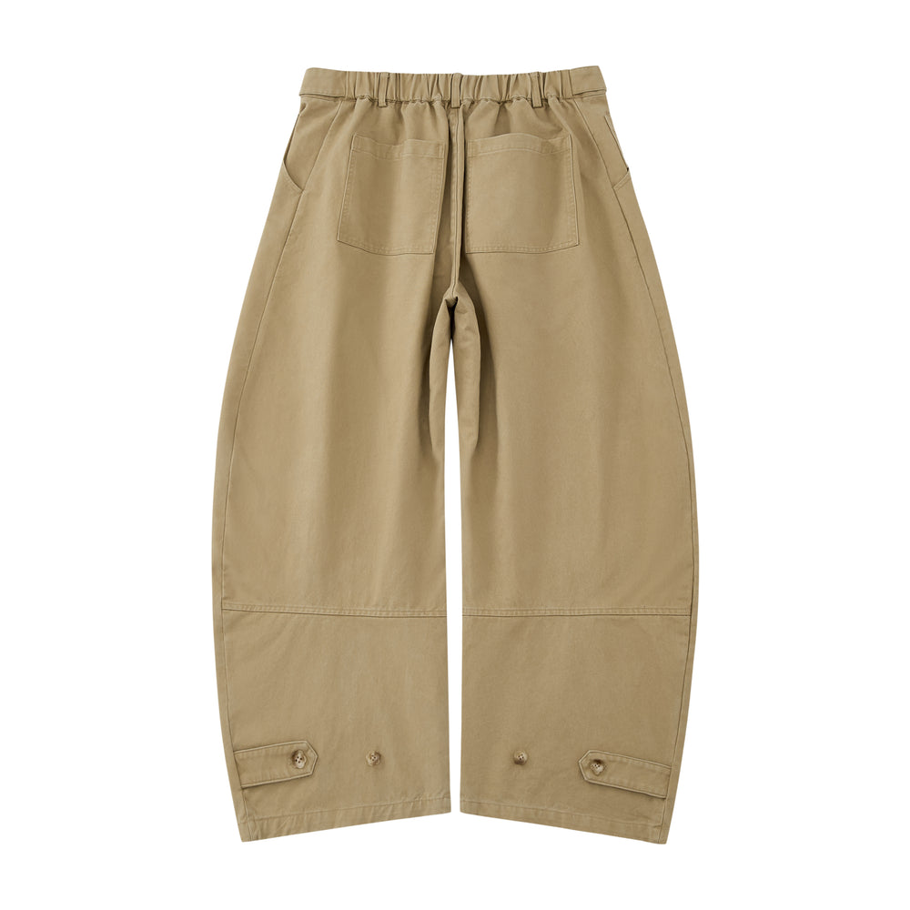 The Tan Hanbok Chino Pants by Sundae School feature a wide-leg, high-waisted barrel-fit chino silhouette with pleats and button details, inspired by classic hanbok styles, shown on a plain white background.