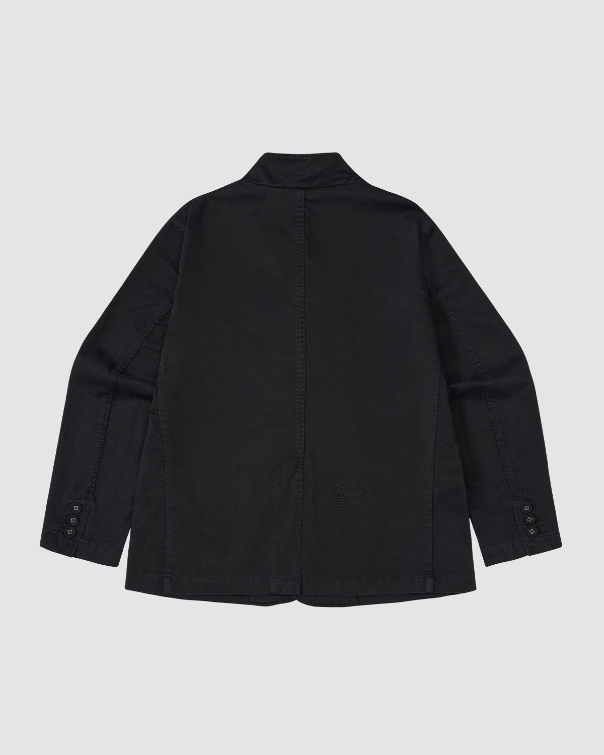 The BLACK JEOGORI TIE JACKET by Sundae School is shown laid flat, back side up, with buttoned cuffs, a central back seam, and a refined Jeogori-inspired silhouette for added structure.