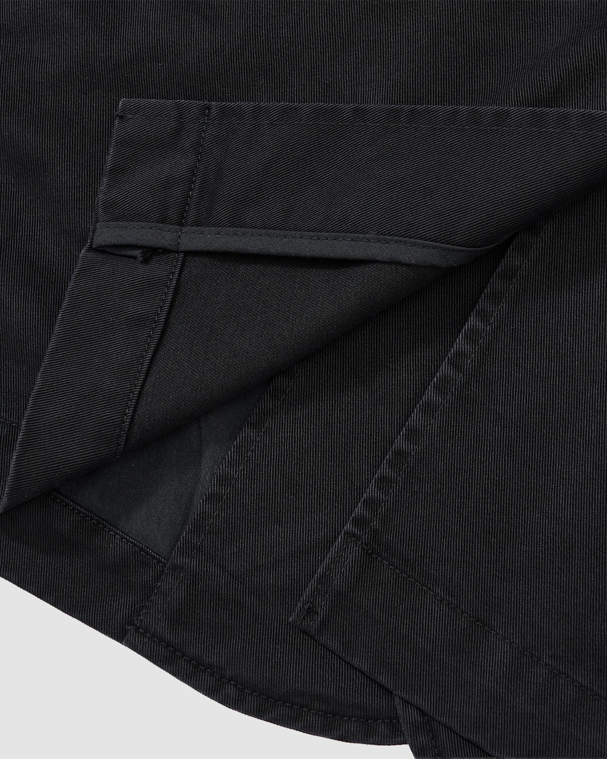 A close-up of the BLACK JEOGORI TIE JACKET by Sundae School highlights its dark, textured fabric, neat hem and inside seam, Jeogori silhouette with monk collar, precise stitching, and cleanly finished edges.