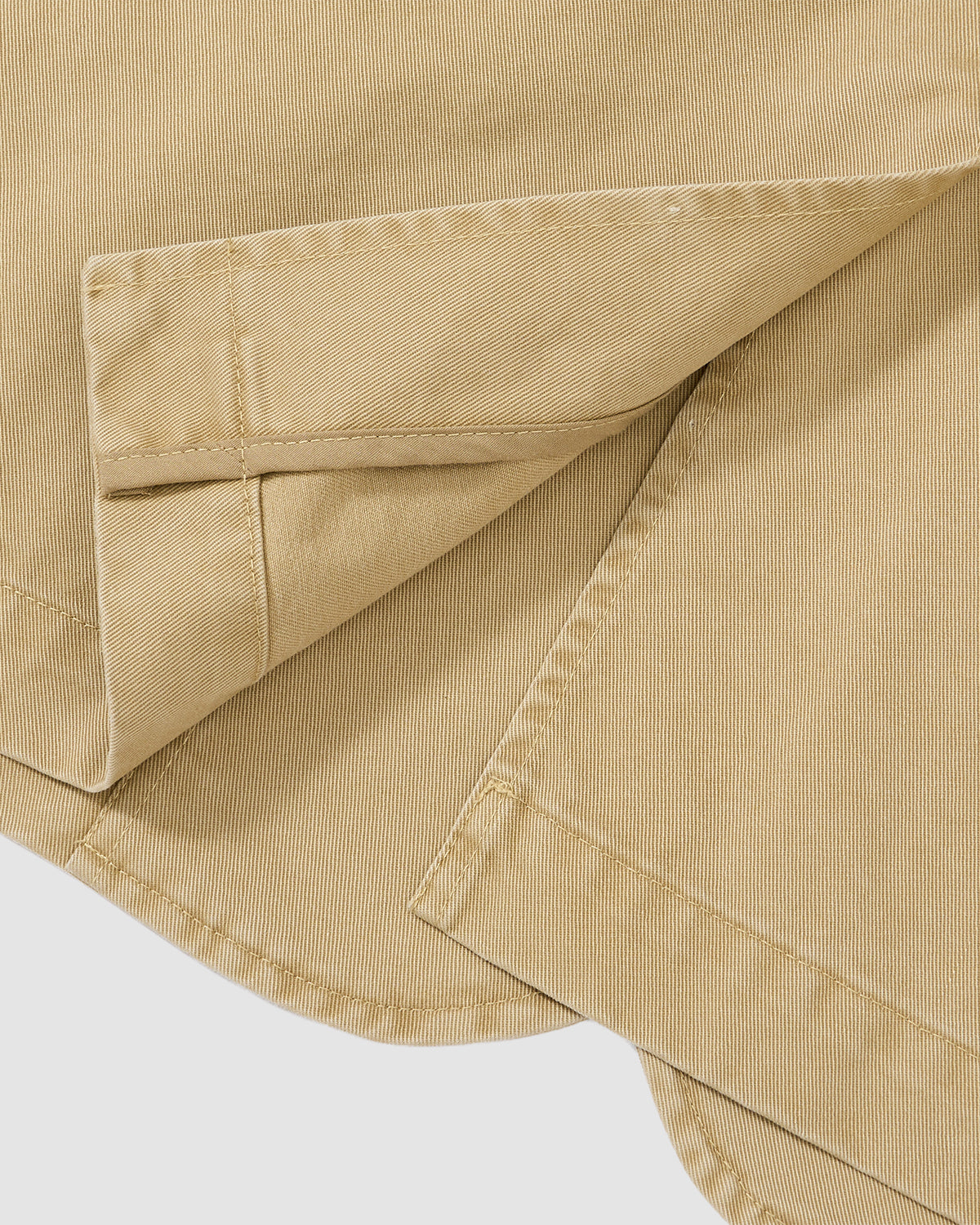 Close-up of the TAN JEOGORI TIE JACKET by Sundae School, showcasing beige fabric and visible stitching with overlapping layers—evoking a classic jeogori silhouette ideal for refined summer style.