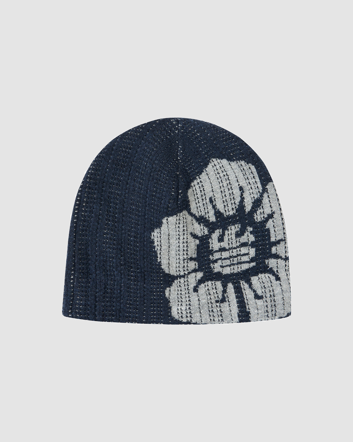 The NAVY DDUL KNIT BEANIE by Sundae School is a dark blue beanie with a large white flower on the side, made from breathable spring jersey for comfort and style.