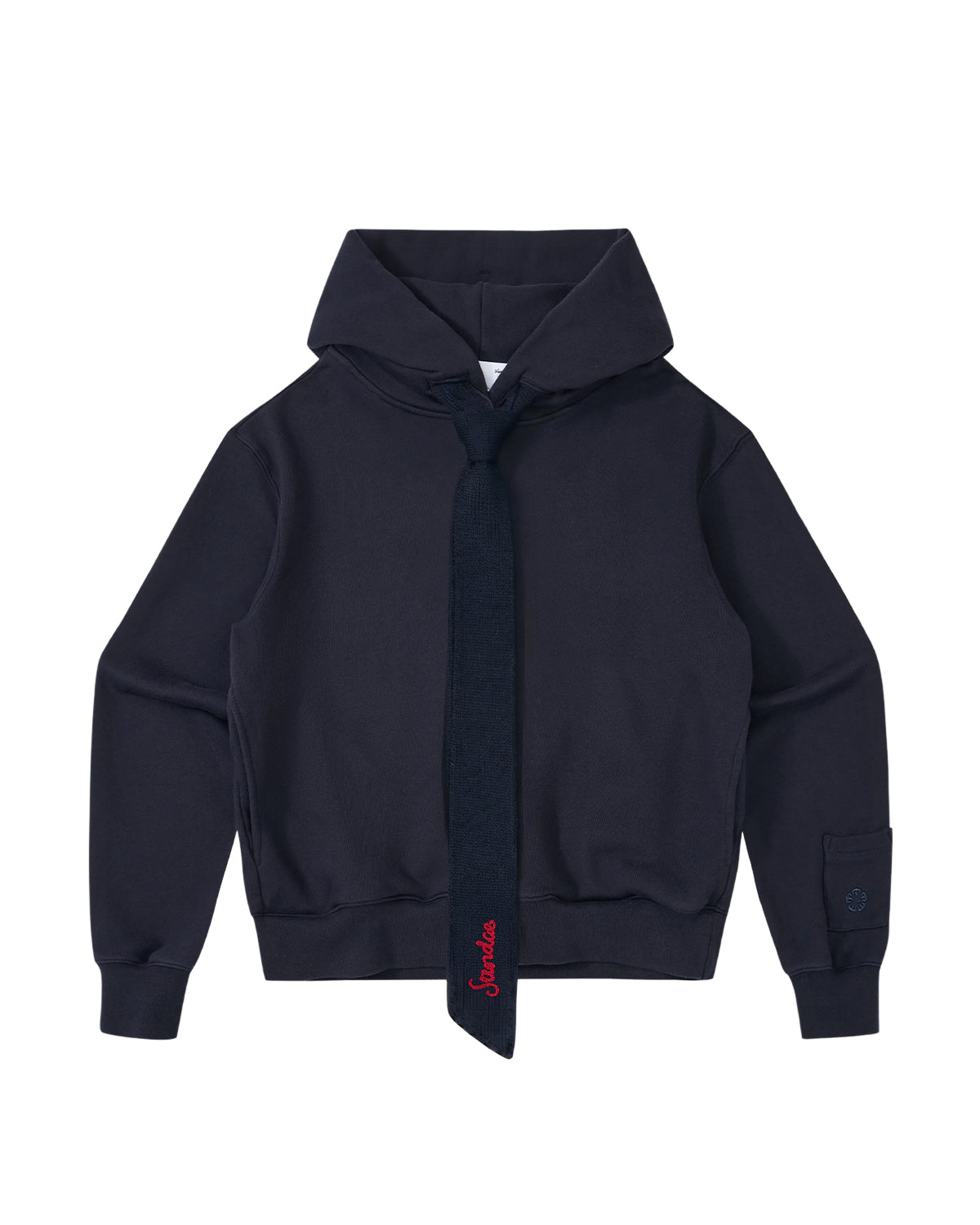 The Sundae School NAVY KNIT TIE HOODIE is a unisex heavyweight hoodie in navy blue, made from brushed cotton for enhanced comfort and style. It features a matching attached tie and a subtle red embroidered accent near the bottom of the tie.