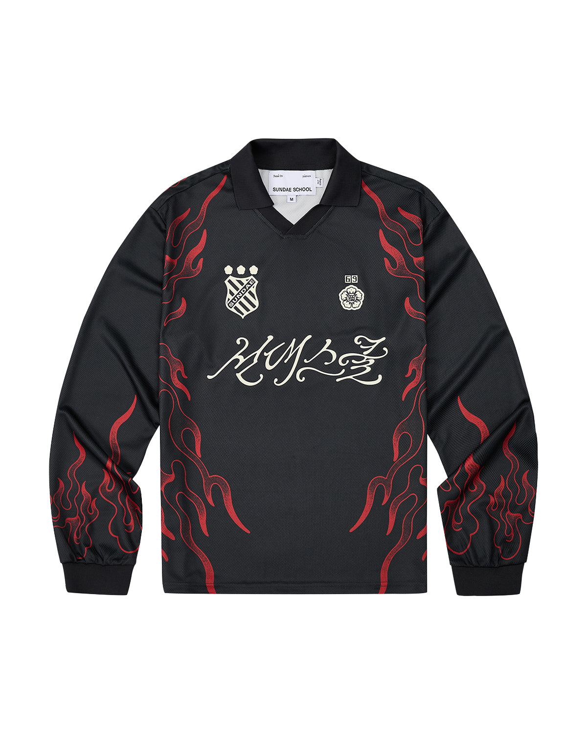 Sundae School’s KOREATOWN FOOTBALL JERSEY features black long sleeves accented with red flame designs along the sleeves and sides, white logos and badges on the chest, and bold stylized calligraphy across the front—a striking piece inspired by K-Town fashion, perfect for fans of custom lettered apparel.