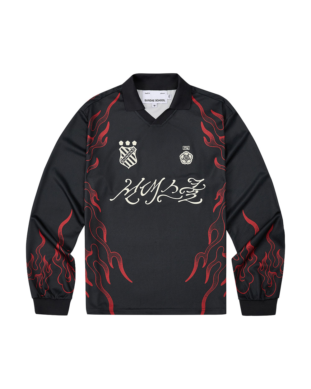 Sundae School’s KOREATOWN FOOTBALL JERSEY features black long sleeves accented with red flame designs along the sleeves and sides, white logos and badges on the chest, and bold stylized calligraphy across the front—a striking piece inspired by K-Town fashion, perfect for fans of custom lettered apparel.