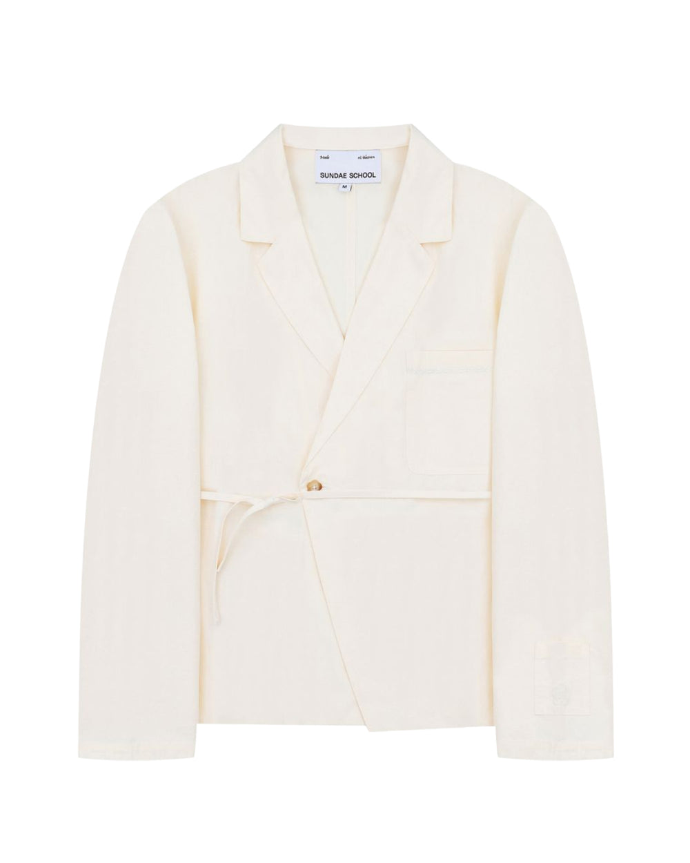 An ivory linen “Gorum Blazer” by Sundae School, featuring a single button closure, tied fabric belt, notched lapels, and a chest pocket. The label inside reads Sundae School.