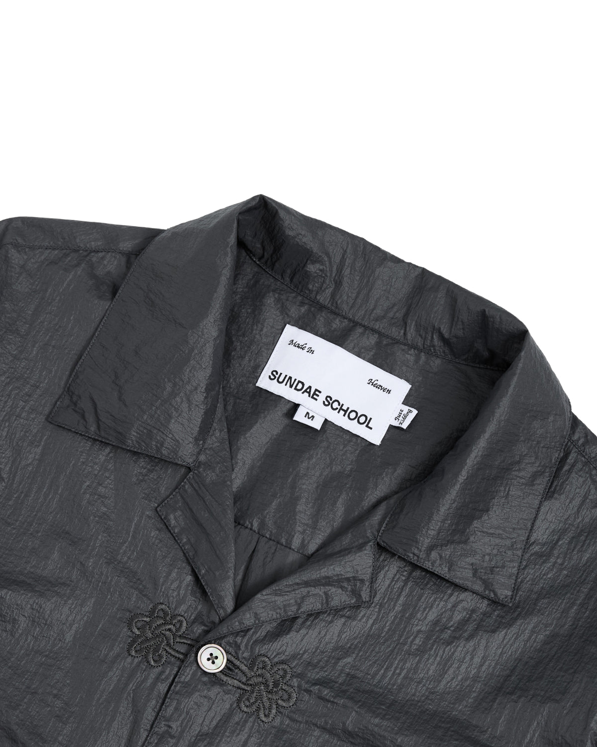 A close-up of Sundae School's MAEHWA EMBROIDERED SHEER SHIRT in dark gray, made from nylon sheer fabric. The unisex, collared going-out shirt features a visible 