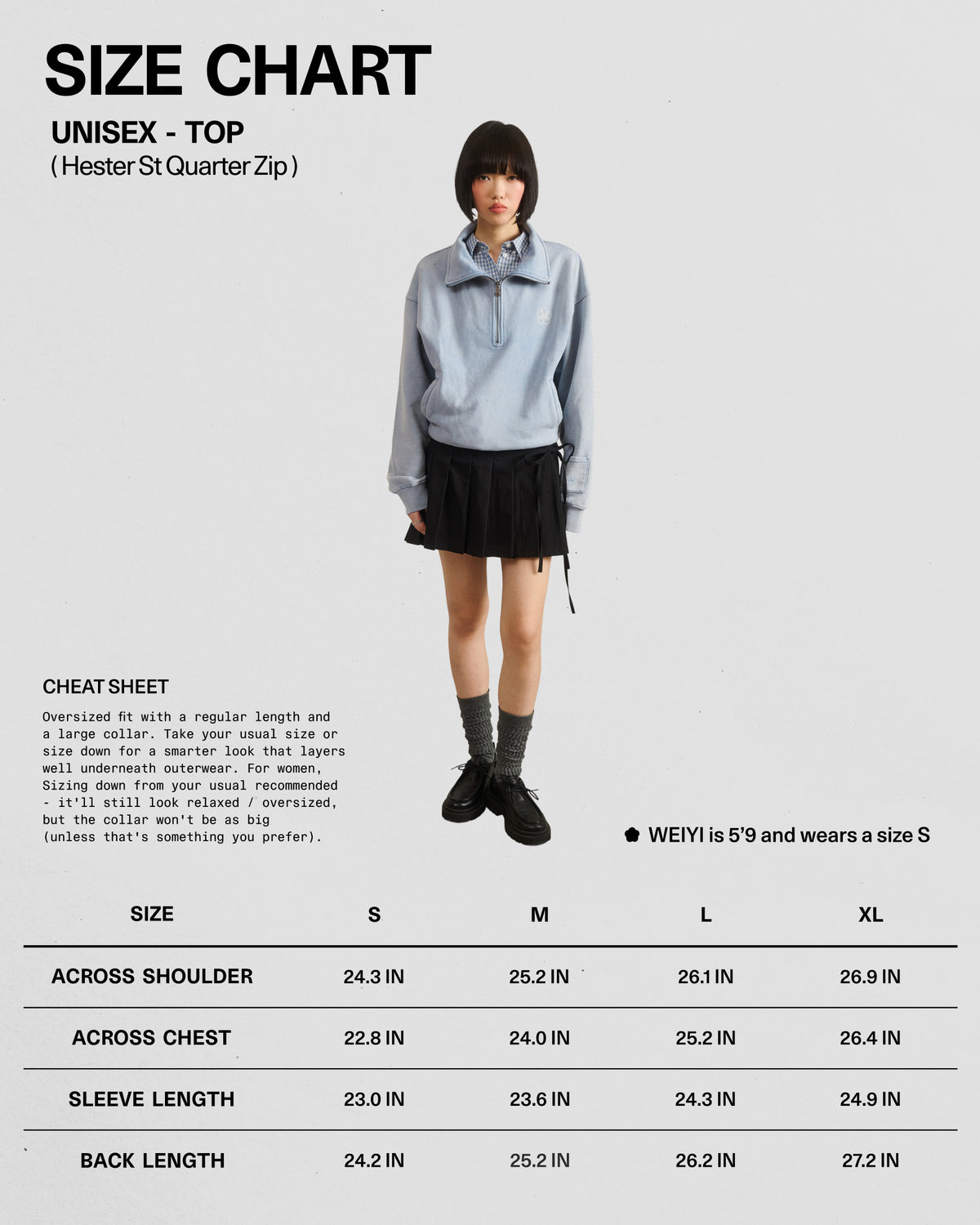 A person wearing the Sundae School SKY BLUE HESTER QUARTER ZIP—a light blue oversized quarter zip hoodie with a funnel neck collar—paired with a black skirt, gray socks, and black shoes stands in front of a size chart for the unisex vintage cotton pullover sweatshirt, which displays measurements for sizes S to XL.