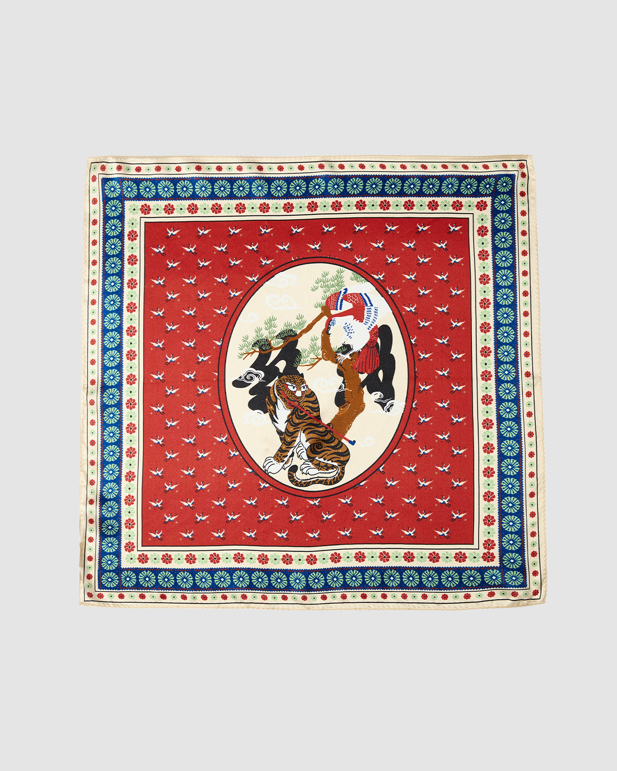 The MINHWA BANDANA by Sundae School is a square silk scarf inspired by Korean folk art, with a red background, ornate borders, and an oval center showing two women in traditional attire amid floral and geometric patterns—a unique luxury gift.