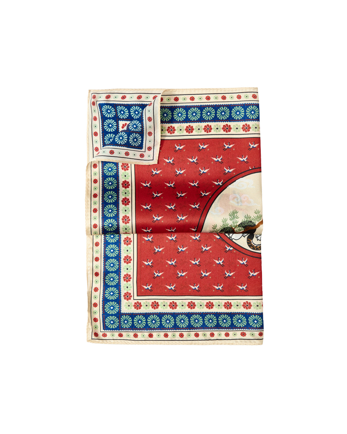 A folded red MINHWA BANDANA by Sundae School, crafted in silk and adorned with a blue, cream, and green floral border, delicate white bird patterns, and a circular motif depicting a tree and birds. A matching smaller square rests at the top left corner, making this piece both a luxurious gift and a narrative-driven masterpiece inspired by Korean folk art.