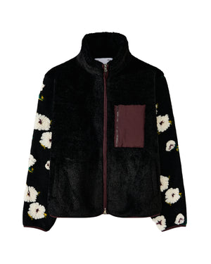 The MUGUNGHWA FLEECE by Sundae School is a black zip-up sherpa fleece jacket adorned with white floral motifs inspired by the Korean national flower on the sleeves, and features a maroon chest pocket on the left side.