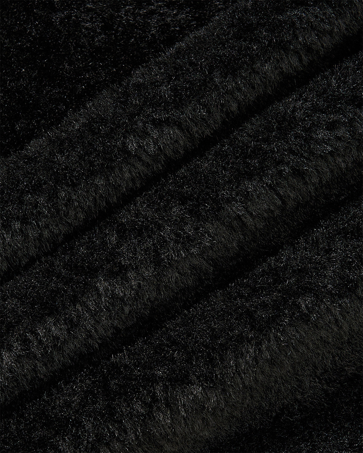 Close-up of Sundae School’s MUGUNGHWA FLEECE in black, showcasing its soft and fluffy fabric with a dense, sherpa-like texture and gentle, wavy diagonal lines throughout.