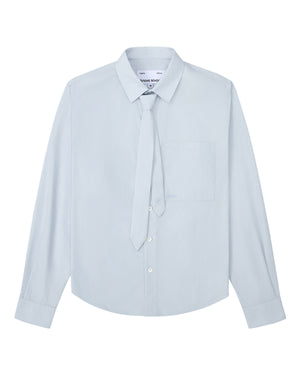 The NECKTIE SHIRT by Sundae School is a light blue long-sleeve poplin shirt featuring a pointed collar, removable matching loose necktie, relaxed fit, and a front left stash pocket. Displayed on a white background.