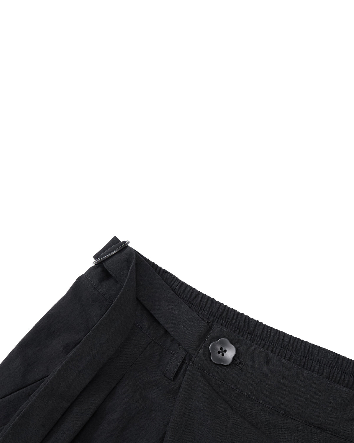 Close-up of the waistband on Sundae School’s BLACK PLEATED PALAZZO PANTS, showing the asymmetric fly, mochi button detail, belt loop, and adjustable side buckle against a plain light gray background.