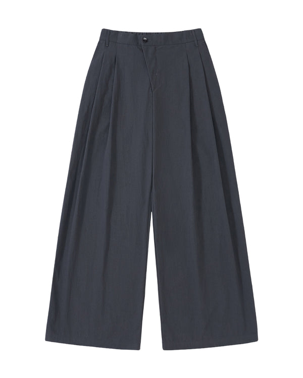 Sundae School CHARCOAL PLEATED UNIFORM SLACKS: wide-leg, high-waisted charcoal trousers with pleats and button closure, displayed flat on a light gray background.