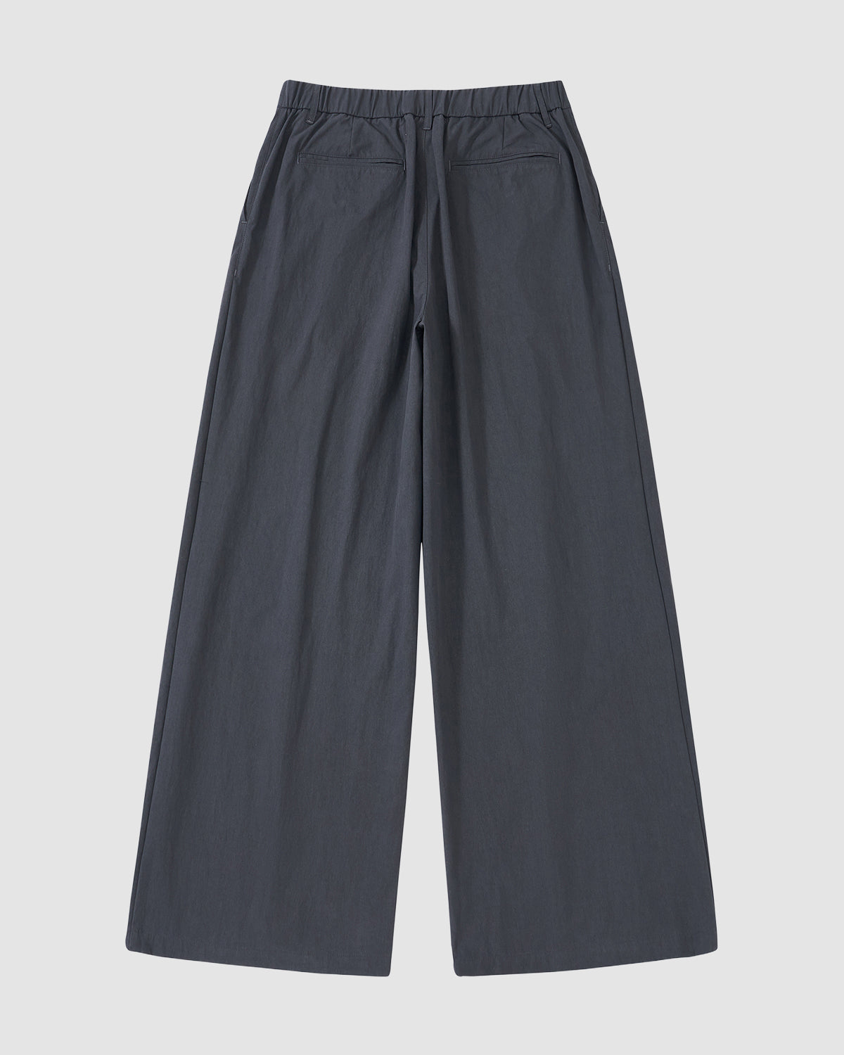 The CHARCOAL PLEATED UNIFORM SLACKS by Sundae School feature a wide-leg fit, elastic waistband, and two back pockets, shown laid flat on a light background.