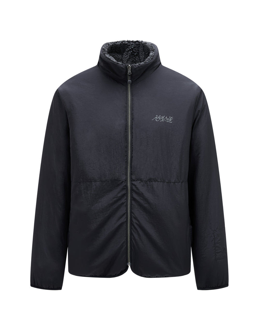 Introducing the BLACK REVERSIBLE IREZUMI FLEECE by Sundae School: a black zip-up jacket with a high collar, crafted with a soft, textured jacquard fleece inner lining and detailed with subtle white logo embroidery on the left chest. This reversible design delivers versatile style, ensuring both functionality and fashion.