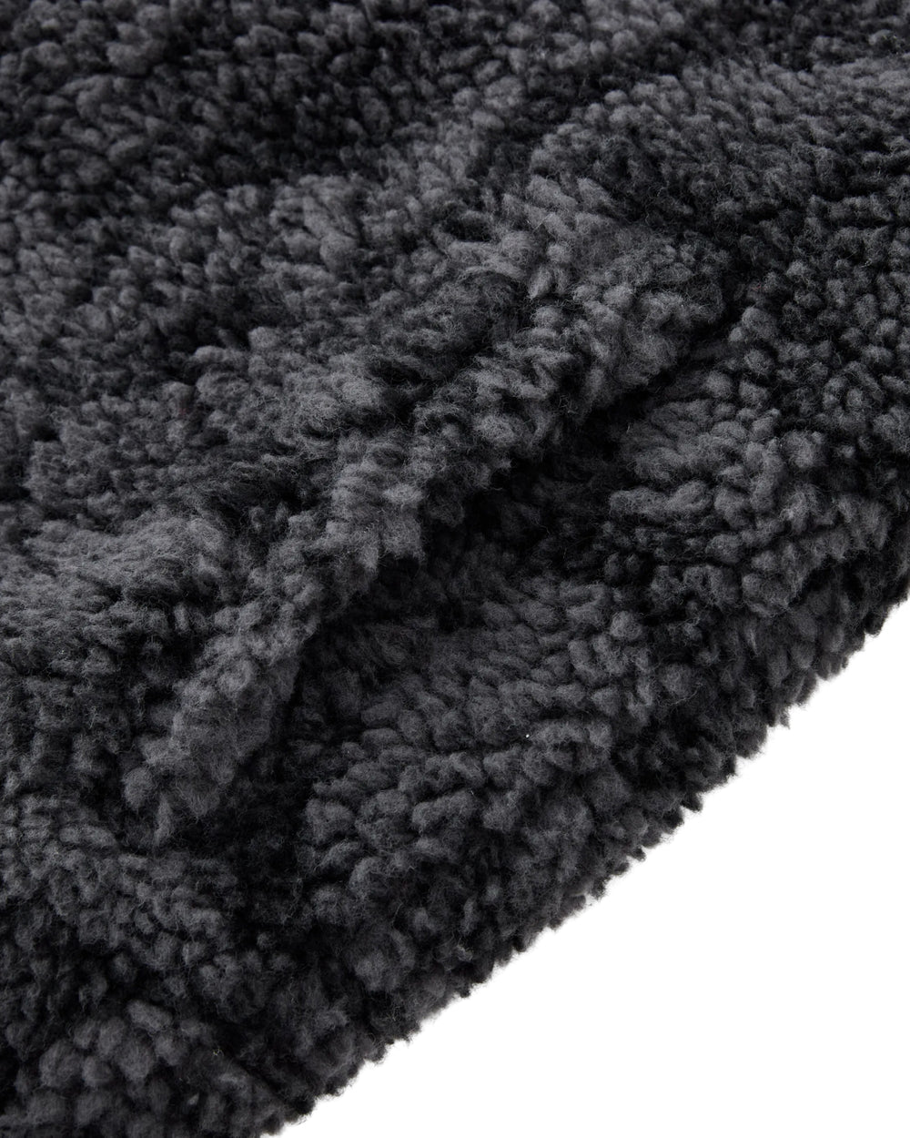 Close-up of the BLACK REVERSIBLE IREZUMI FLEECE by Sundae School, featuring soft, dark gray jacquard fleece with dense, curly fibers for a cozy and inviting texture. The plush surface is perfect for this reversible jacket adorned with striking tiger and dragon graphics.