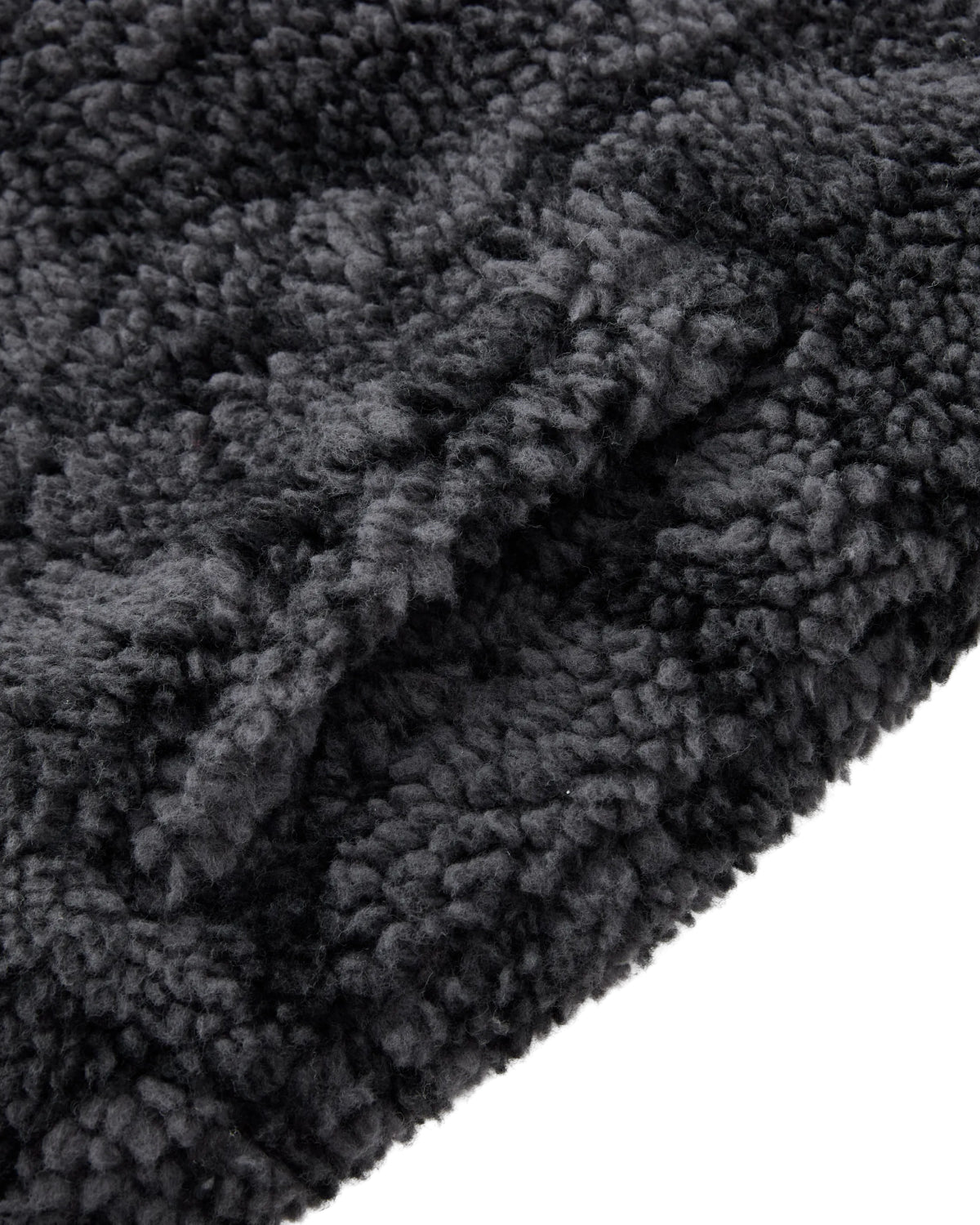 Close-up of the BLACK REVERSIBLE IREZUMI FLEECE by Sundae School, featuring soft, dark gray jacquard fleece with dense, curly fibers for a cozy and inviting texture. The plush surface is perfect for this reversible jacket adorned with striking tiger and dragon graphics.