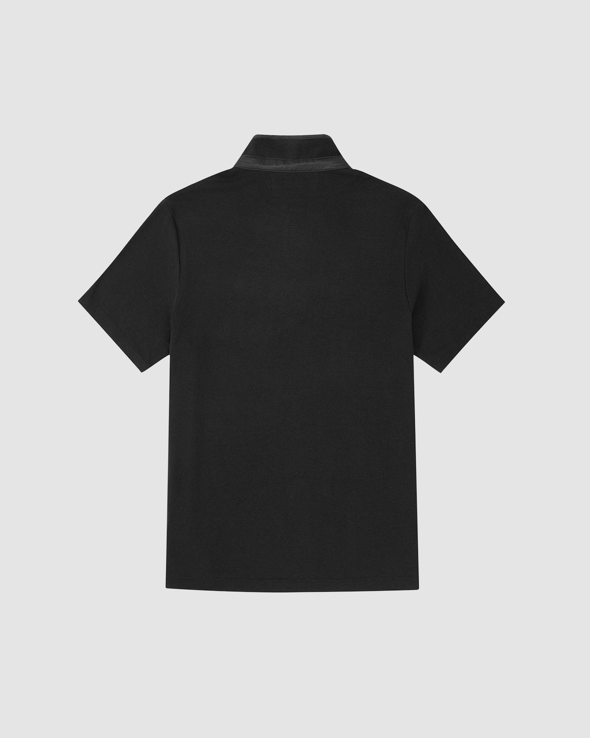 The BLACK RIBBON TIE POLO by Sundae School is a plain black short-sleeve polo with a subtle Manchurian teardrop collar, shown from the back against a light gray background.
