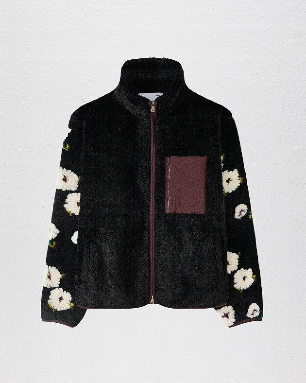 A female model wearing Sundae School Black Mugunghwa Fleece against a brown background.