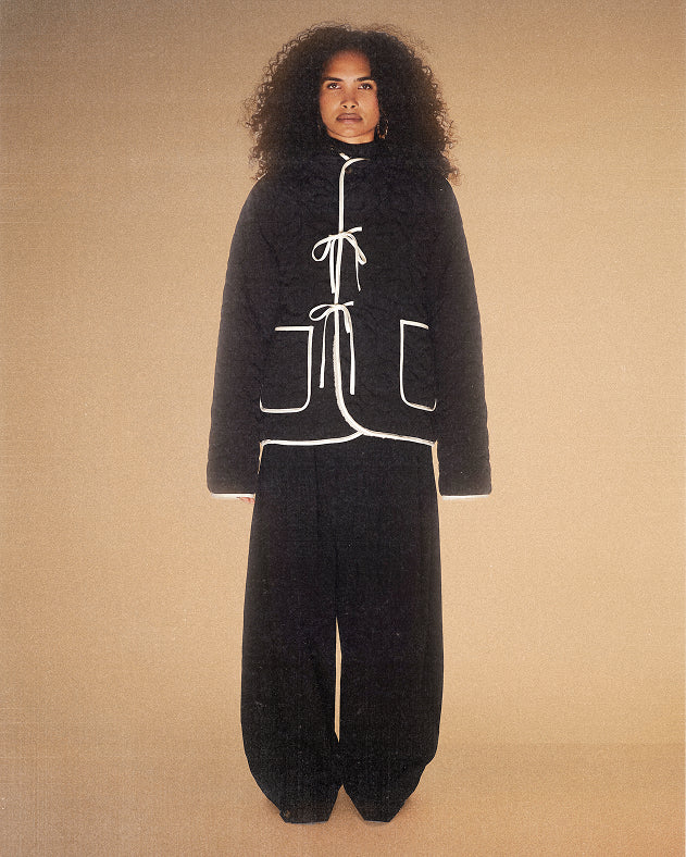 A female model wearing reversible black jeogori fleece 