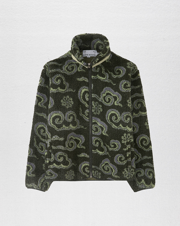 A male model wearing Sundae School Kloud Fleece against a brown background