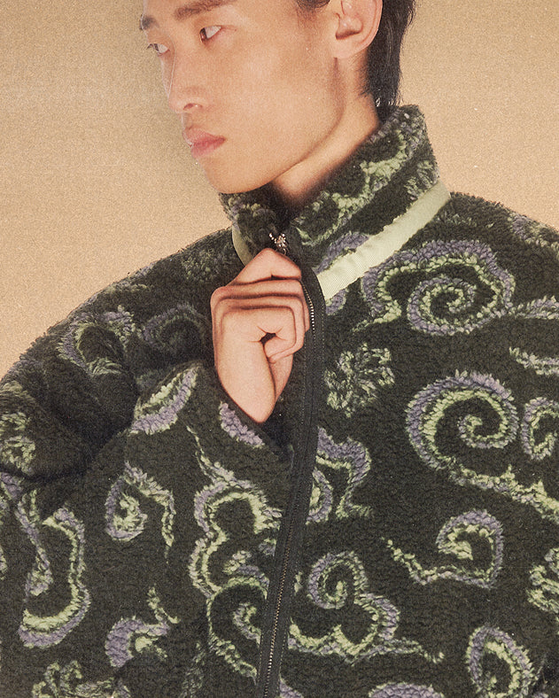 A male model wearing Sundae School Kloud Fleece against a brown background