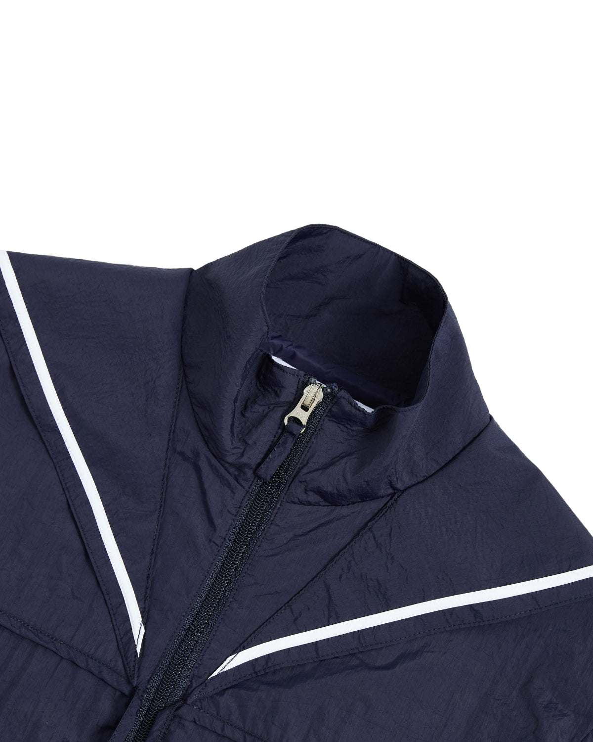 Close-up of the top part of the Sundae School NAVY SAILOR WINDBREAKER, a navy blue cropped jacket with a zipper, featuring white diagonal stripes across the chest and shoulders.