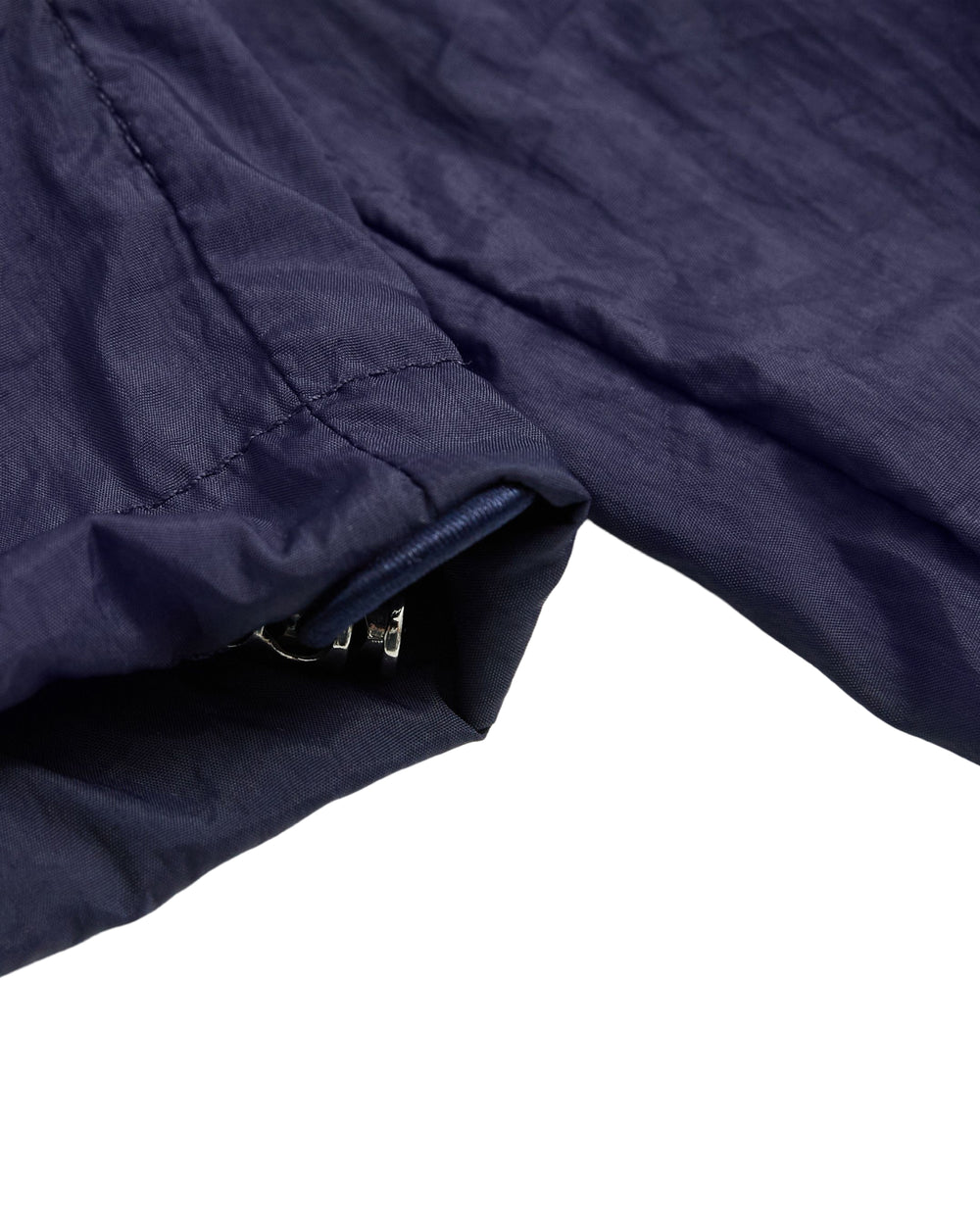 Close-up of the NAVY SAILOR WINDBREAKER by Sundae School, highlighting the dark blue cropped sleeve with a partially visible zipper at the cuff, set against a white background.