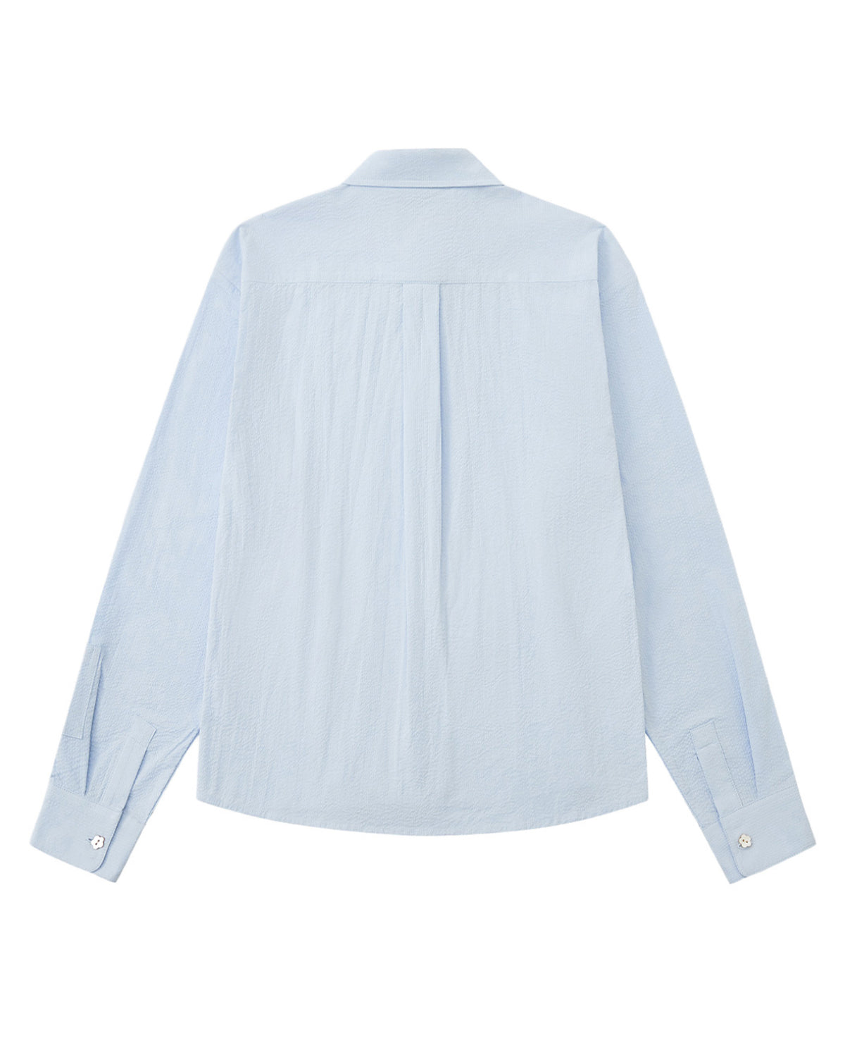 A back flat-lay view of a light blue long-sleeve shirt laid flat against a white background, showing a clean shoulder yoke, a central back box pleat, and buttoned cuffs.