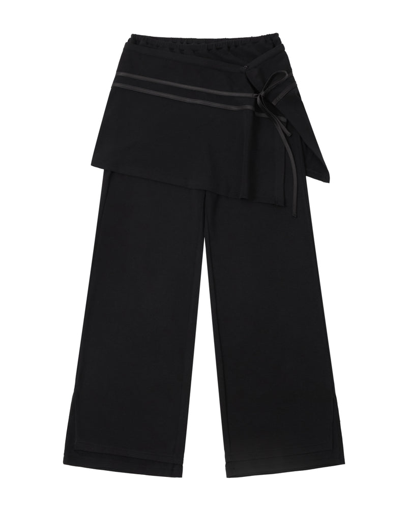 BLACK SEONGSU APRON PANTS: black wide-leg trousers featuring a hybrid wrap skirt front that ties at the side with a ribbon.