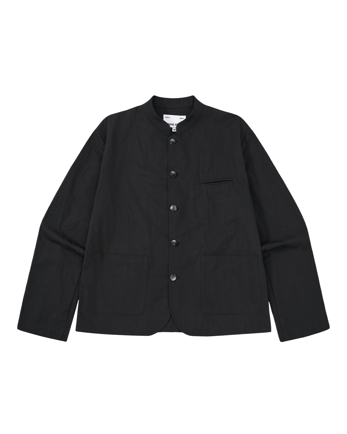The BLACK STAND COLLAR UNIFORM JACKET by Sundae School is a black, wrinkle-resistant cotton-nylon jacket with long sleeves, button-up front, mandarin collar, two large front pockets, and a chest pocket, shown on a light gray background.