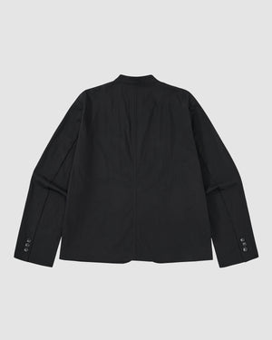 The BLACK STAND COLLAR UNIFORM JACKET by Sundae School is shown flat, back facing up, with long sleeves and buttoned cuffs on a light gray background. Crafted from a cotton nylon blend, it combines durability with style.