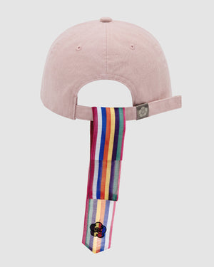 The BABY PINK DAENGGI CAP by Sundae School features an adjustable pale pink cotton design with a rainbow-striped daenggi at the back and a black flower patch, adding a vibrant, modern spin to the classic Korean logo cap.
